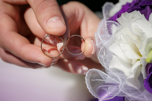 bride and groom holding hands in a ring
